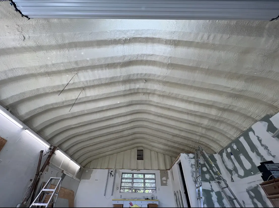 Spray polyurethane foam applied to the underside of a metal roof deck in Horace